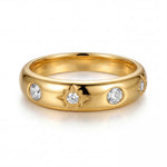 Gold ring with diamond accents on a white background