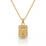 Gold pendant necklace with a detailed design on a white background