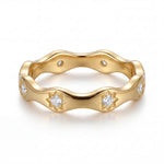 Gold ring with diamond accents on a white background