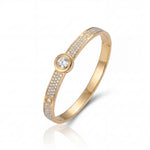 Gold bracelet with diamond accents on a white background