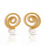 Gold spiral earrings with pearls on a white background