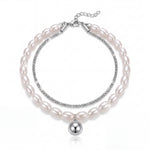 Pearl bracelet with silver accents on a white background