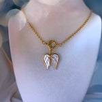 Gold necklace with a heart-shaped pendant on a mannequin bust.