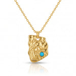 Gold pendant with a turquoise stone on a gold chain against a white background