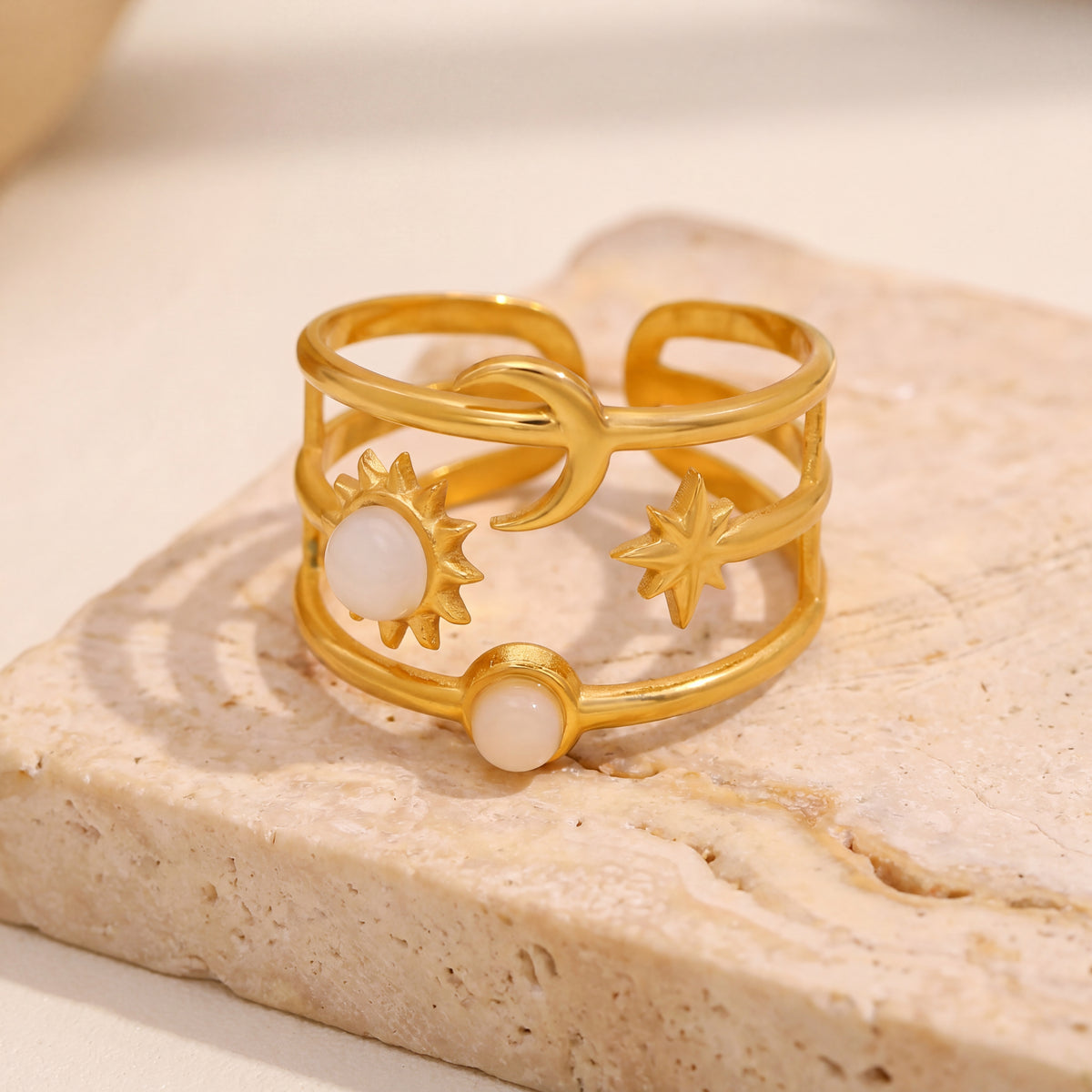 Gold celestial sun and moon adjustable ring with pearl details on stone surface, waterproof stainless steel jewelry