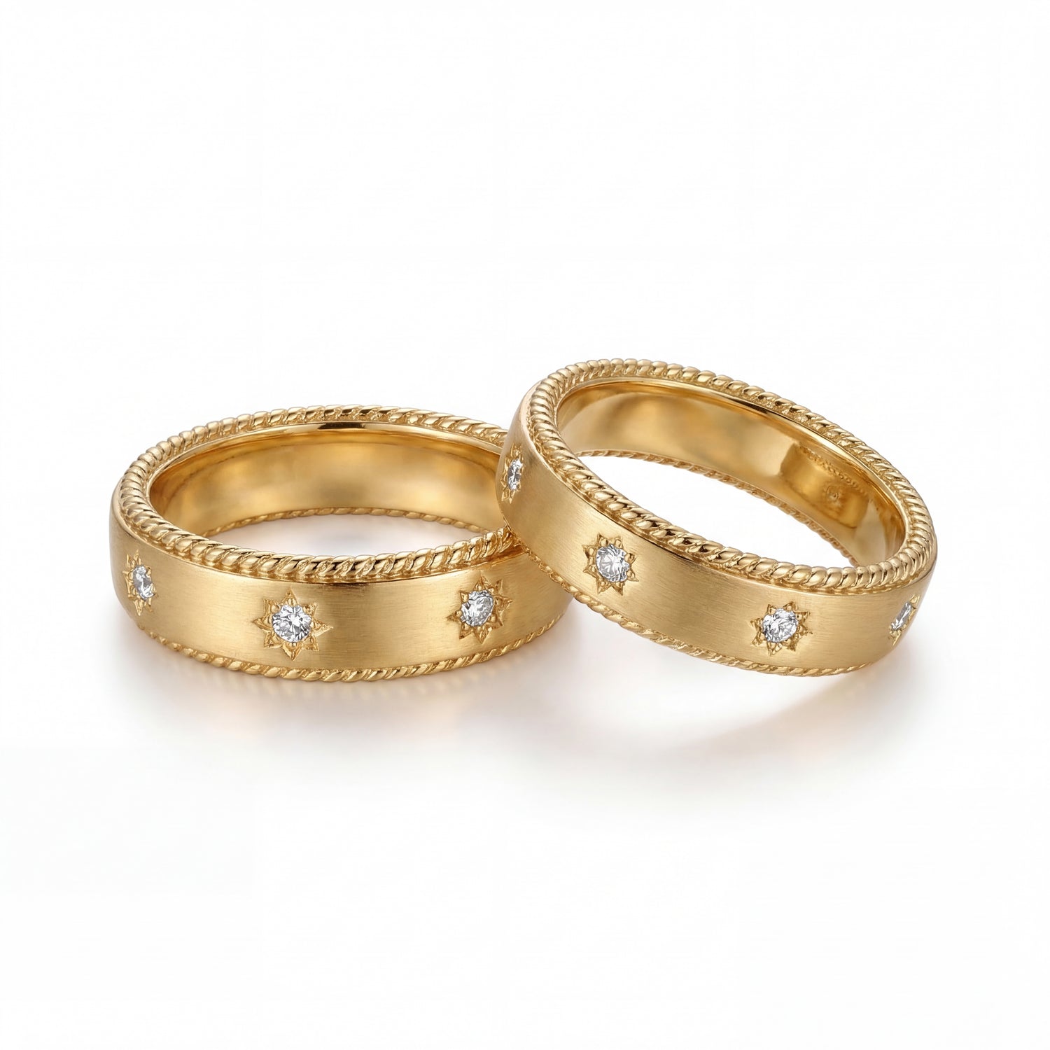 Two gold rings with diamond accents on a white background