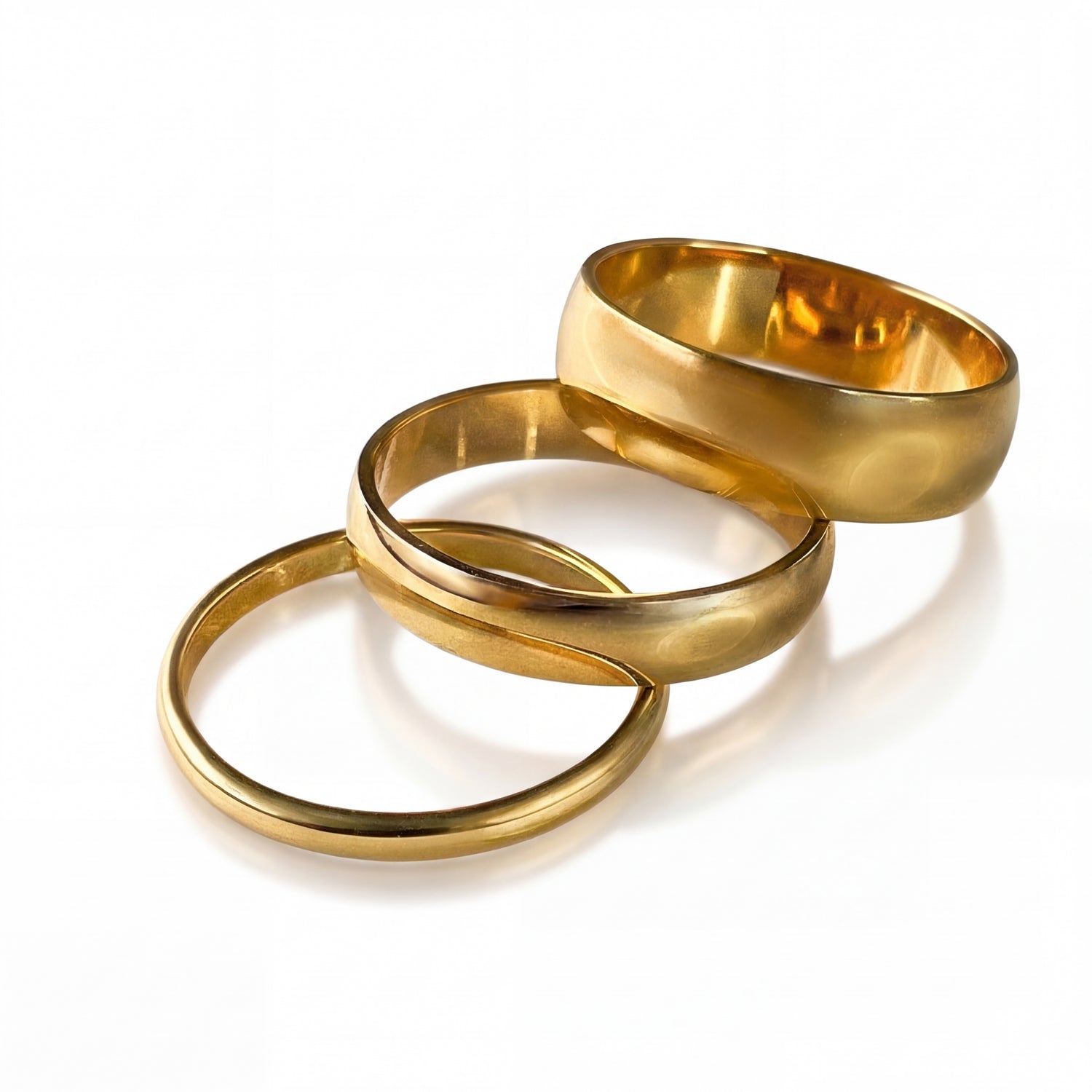 Three gold rings of different sizes on a white background