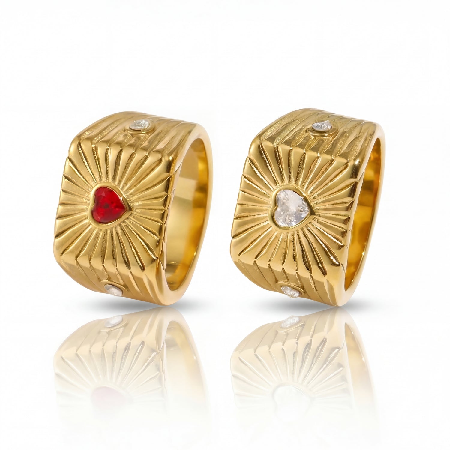 Gold hoop earrings with red and clear gemstones on a white background