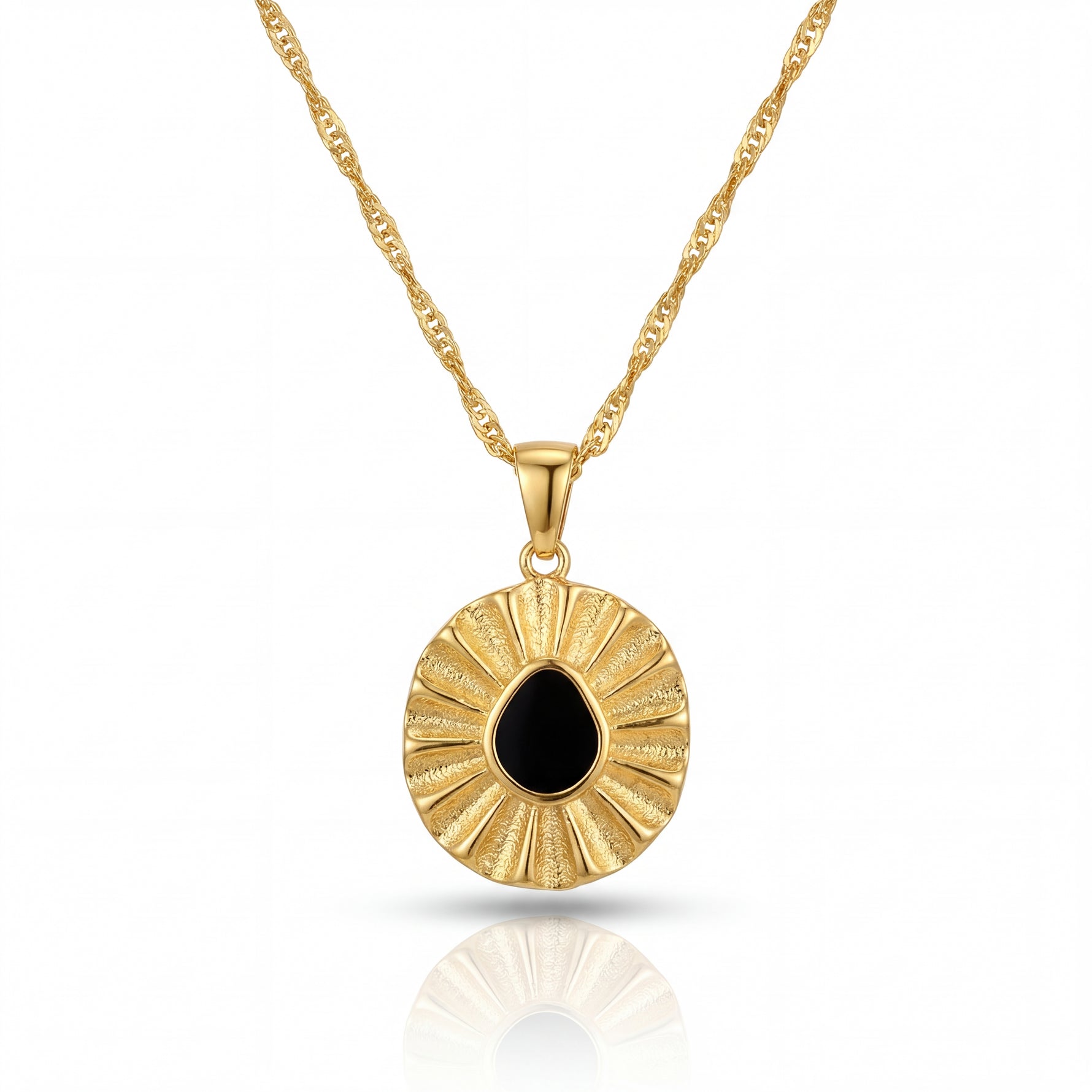 Gold necklace with a round pendant featuring a black stone on a white background