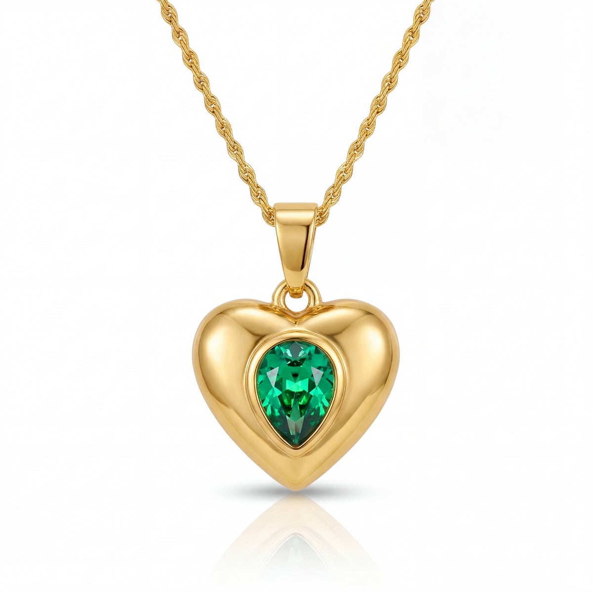 Gold heart-shaped pendant with a green gemstone on a white background