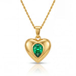 Gold heart-shaped pendant with a green gemstone on a white background