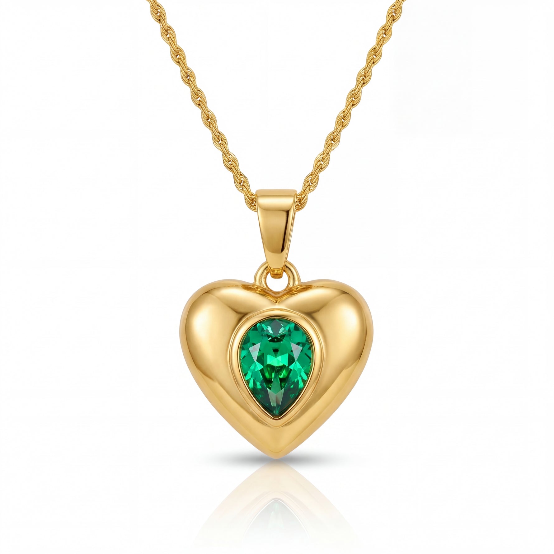 Gold heart-shaped pendant with a green gemstone on a white background