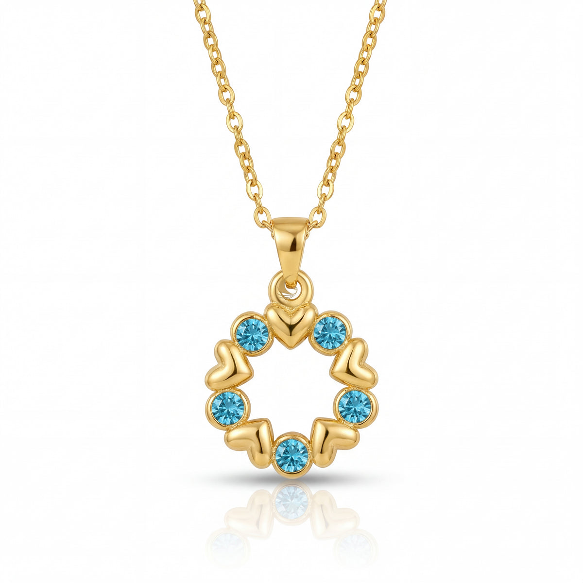 Gold necklace with a circular pendant featuring blue gemstones on a white background