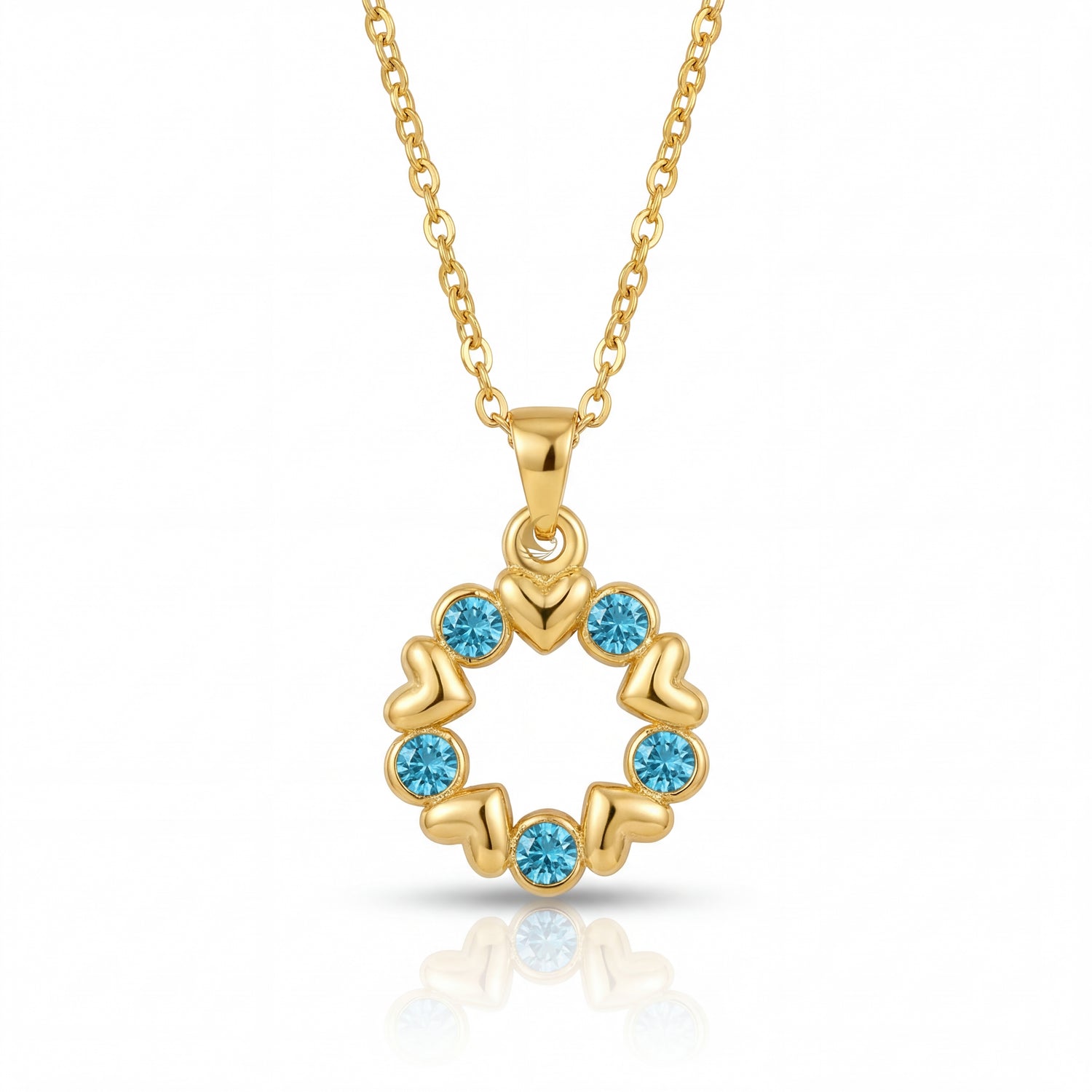 Gold necklace with a circular pendant featuring blue gemstones on a white background
