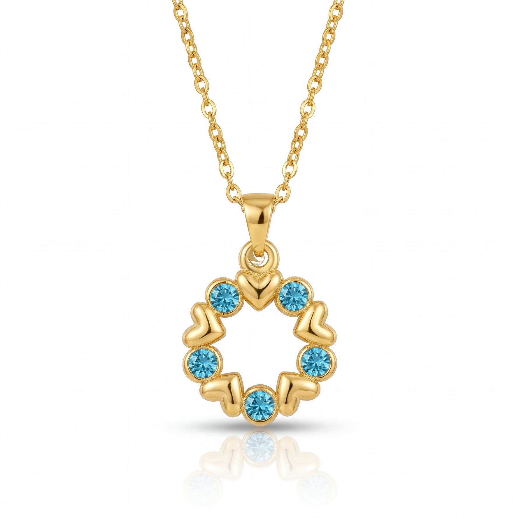 Gold necklace with a circular pendant featuring blue gemstones on a white background