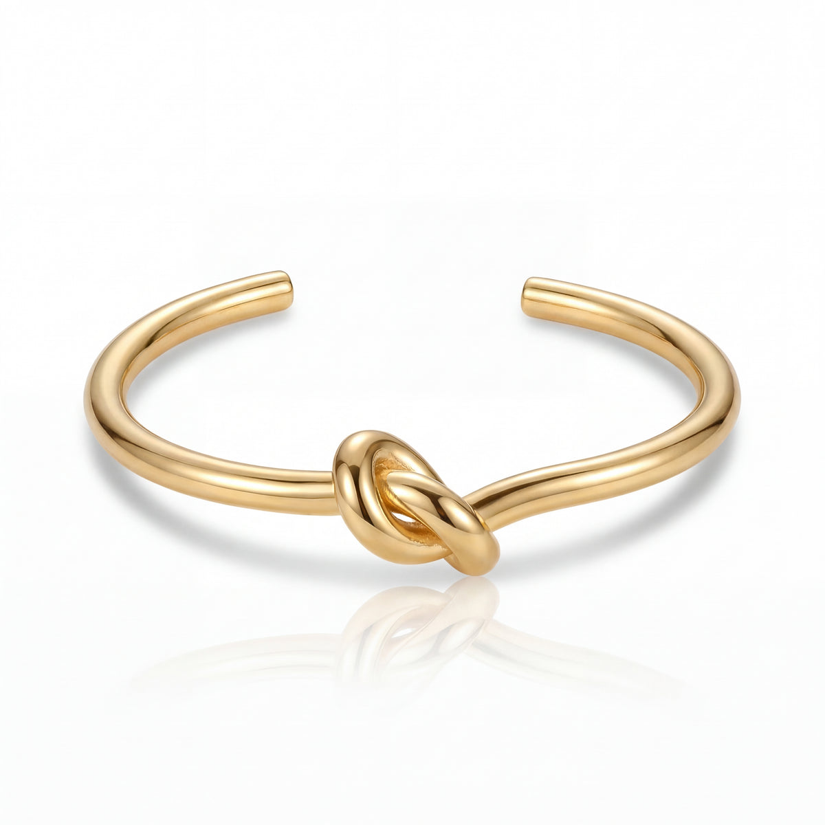 Gold knot bangle on a white background