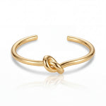 Gold knot bangle on a white background