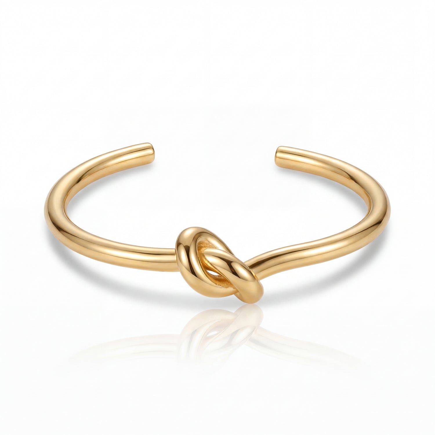 Gold knot bangle on a white background