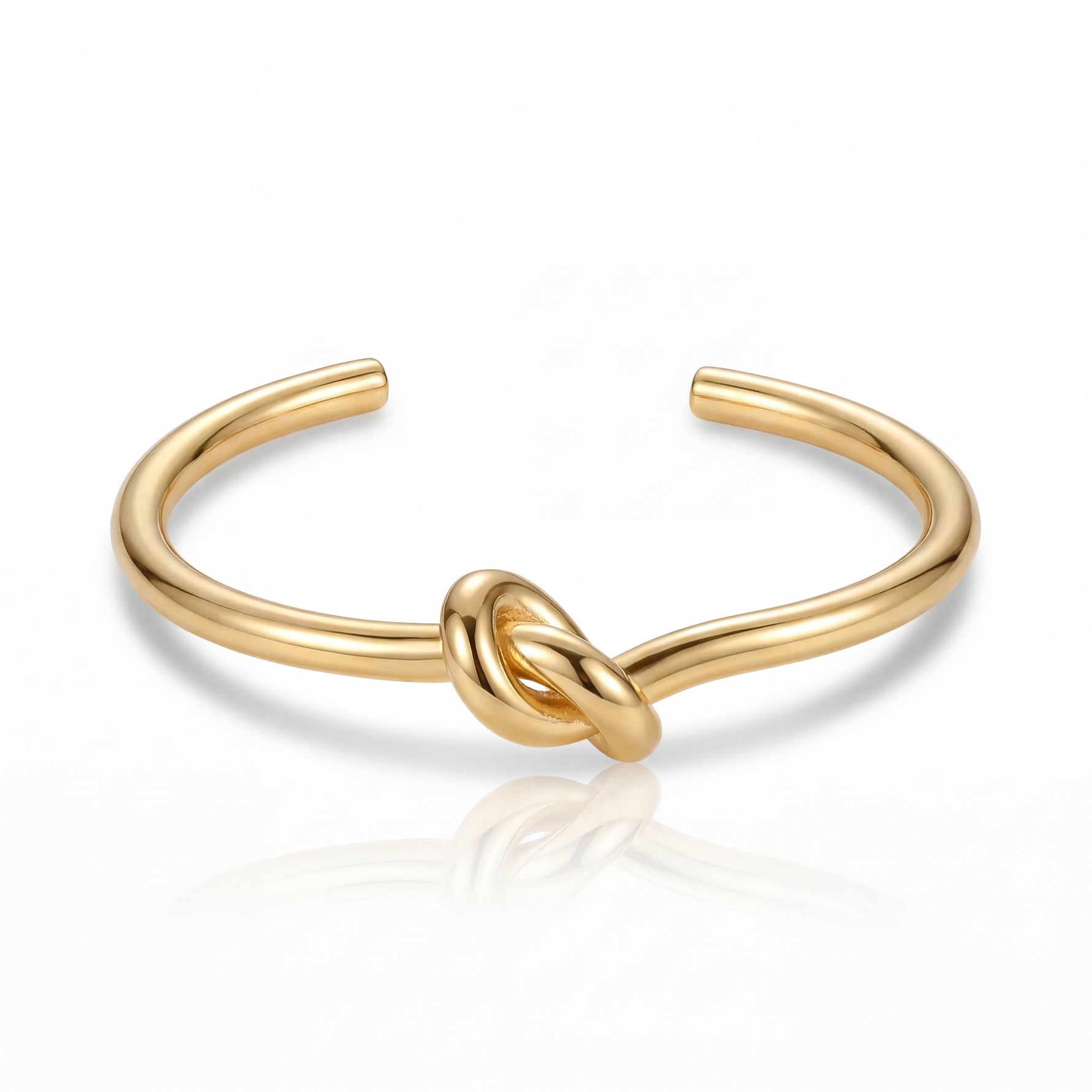 Gold knot bangle on a white background