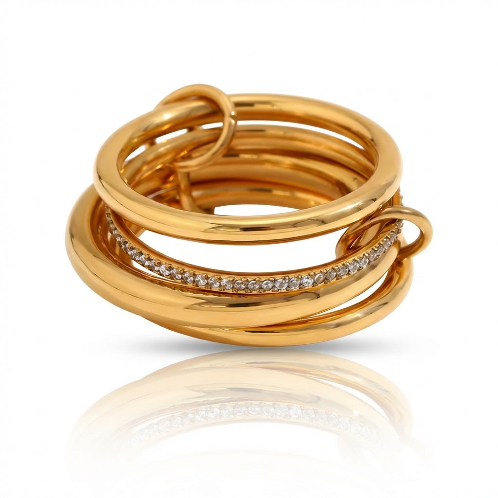 Gold ring with interlocking design and embedded diamonds on a white background