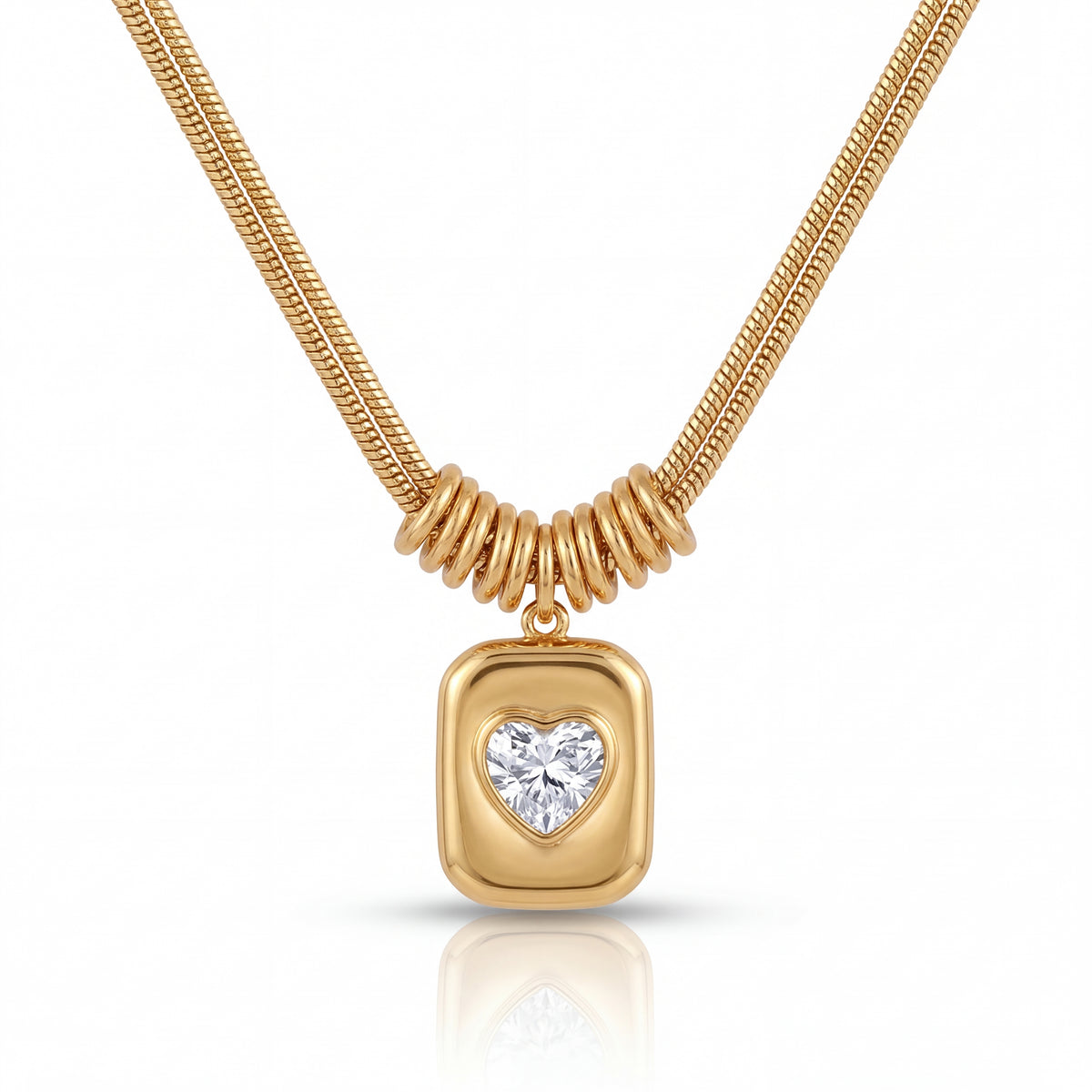 Gold necklace with a heart-shaped diamond pendant on a white background