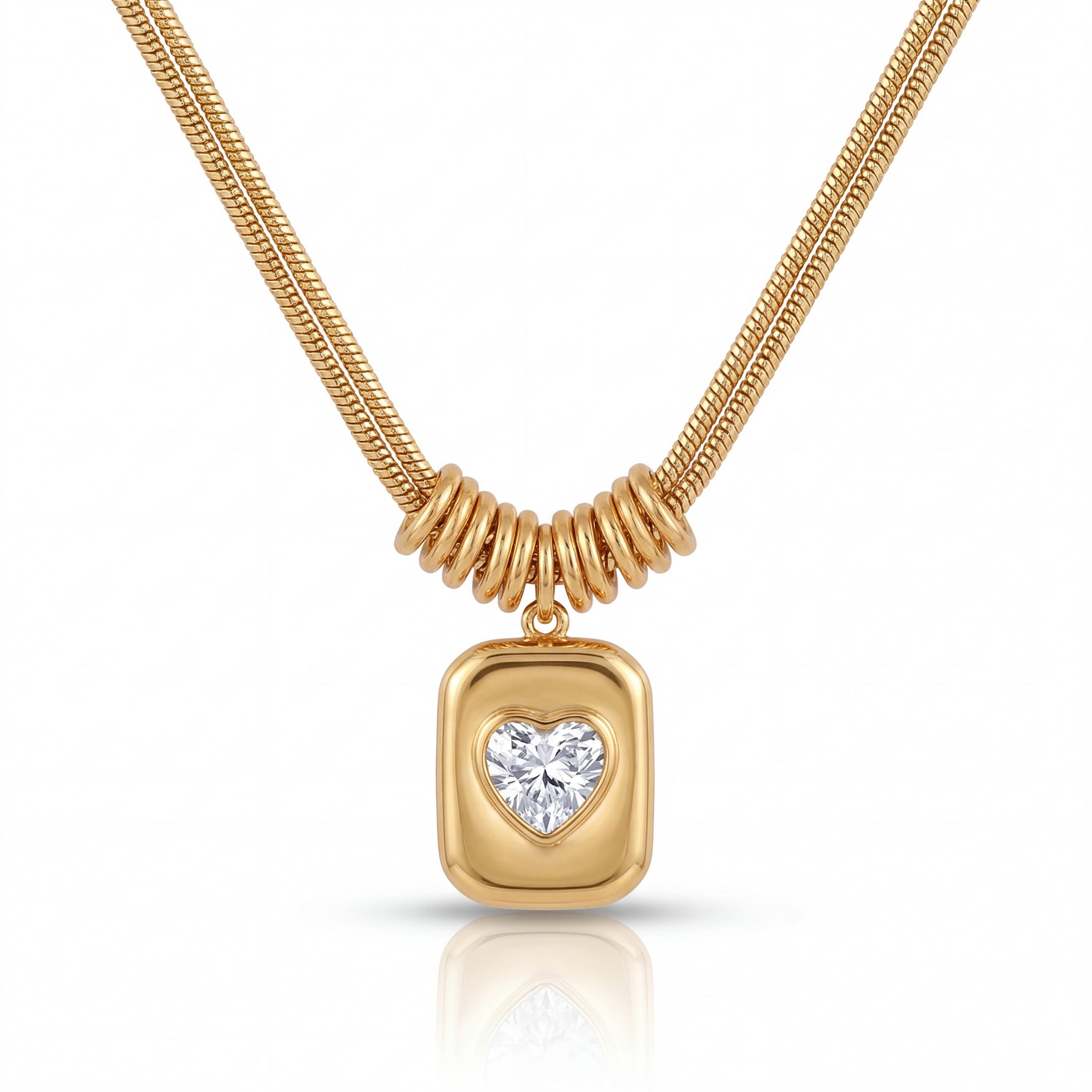 Gold necklace with a heart-shaped diamond pendant on a white background