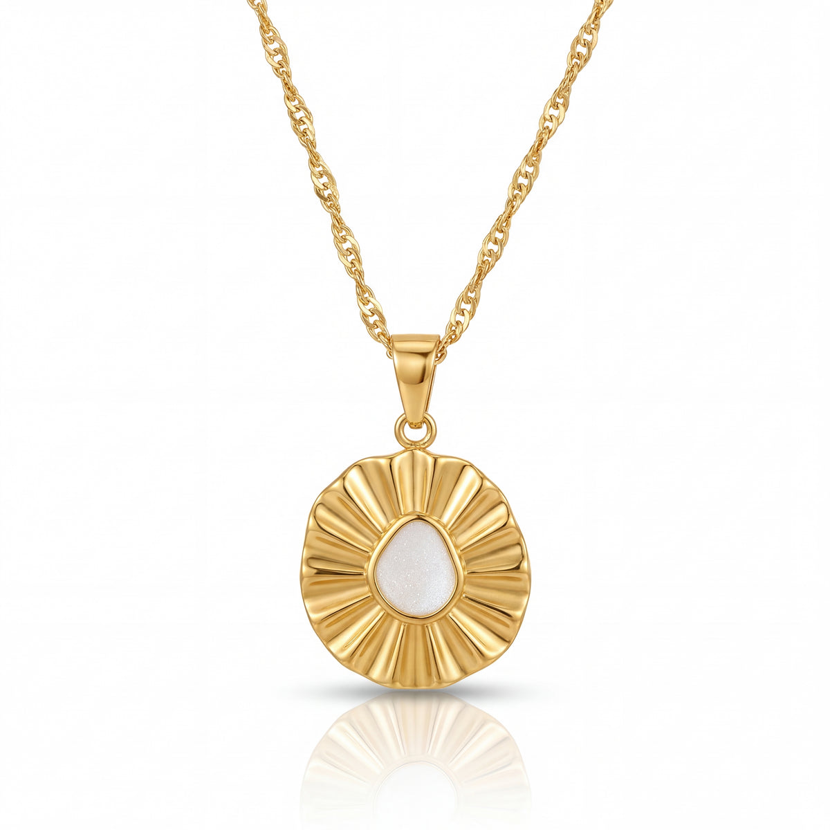 Gold necklace with a circular pendant on a white background