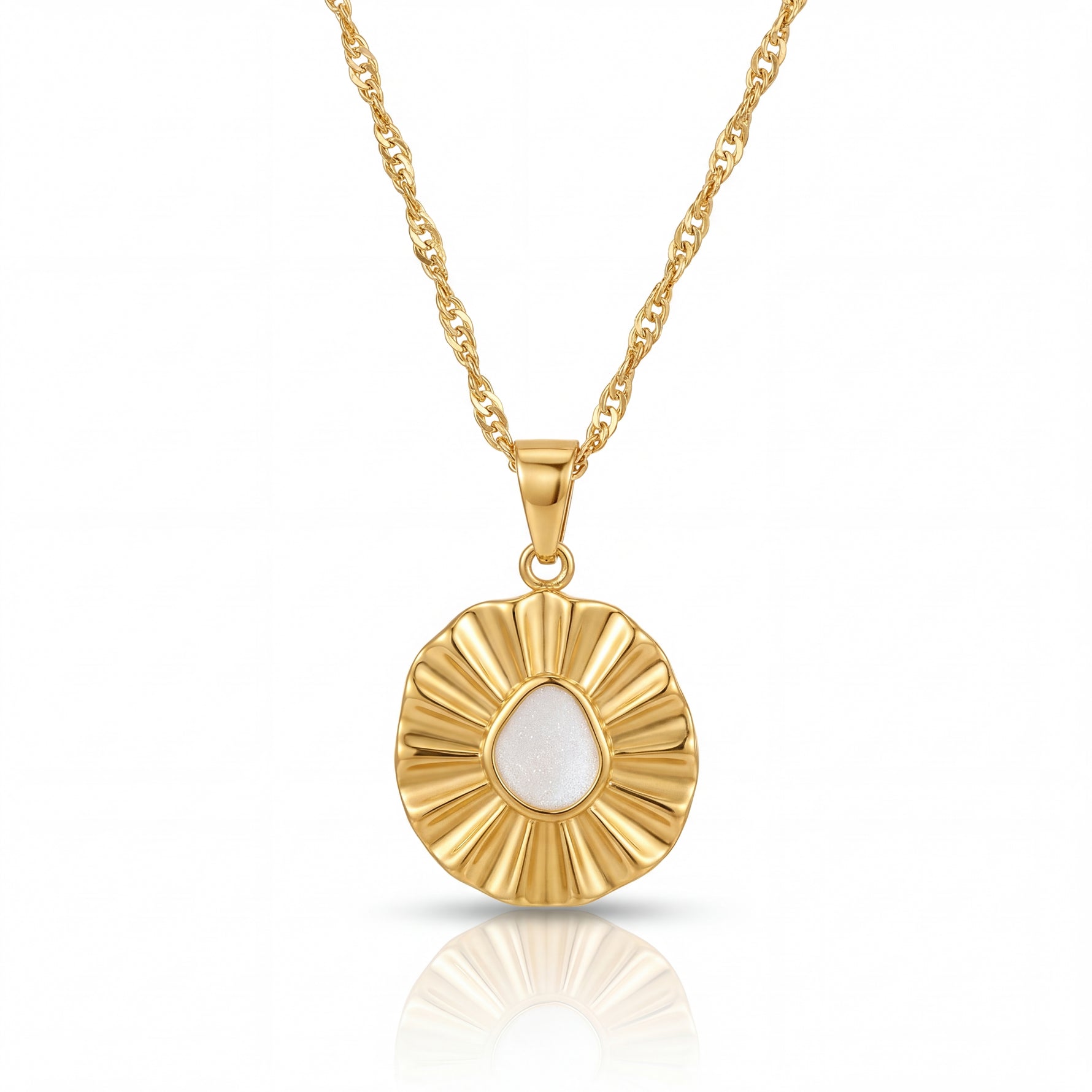 Gold necklace with a circular pendant on a white background