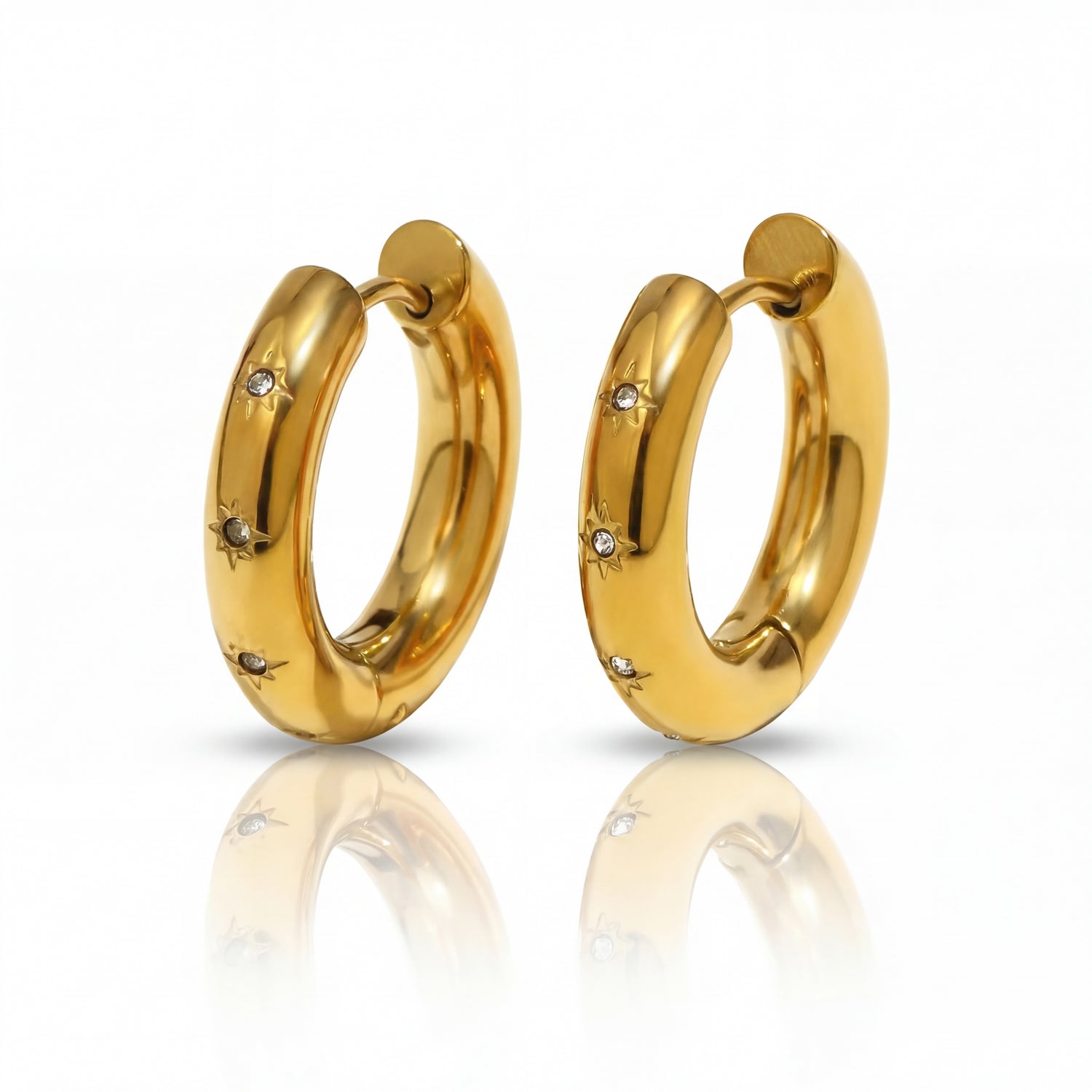 Gold hoop earrings with small diamonds on a white background