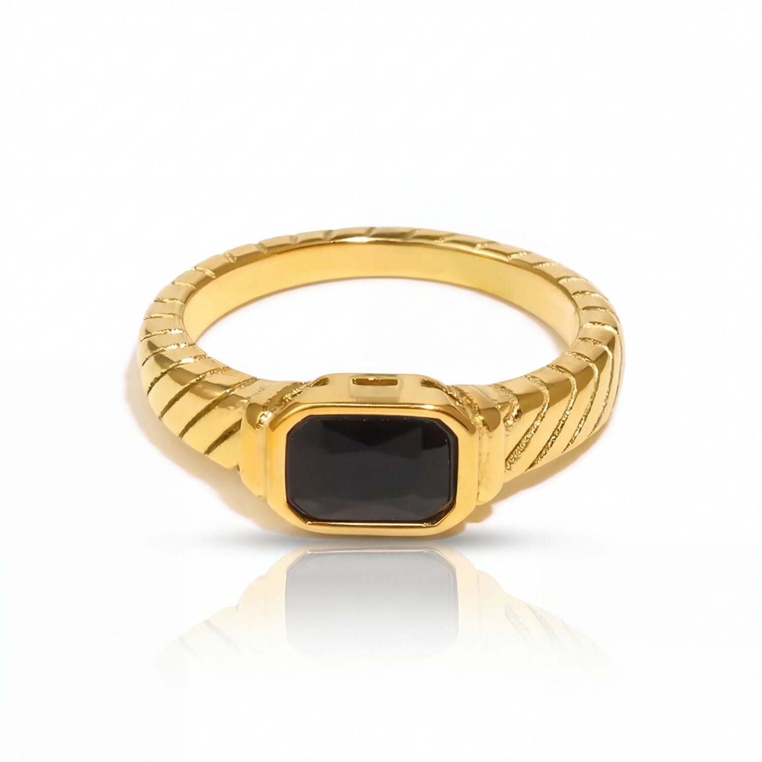 Gold ring with a black gemstone on a white background
