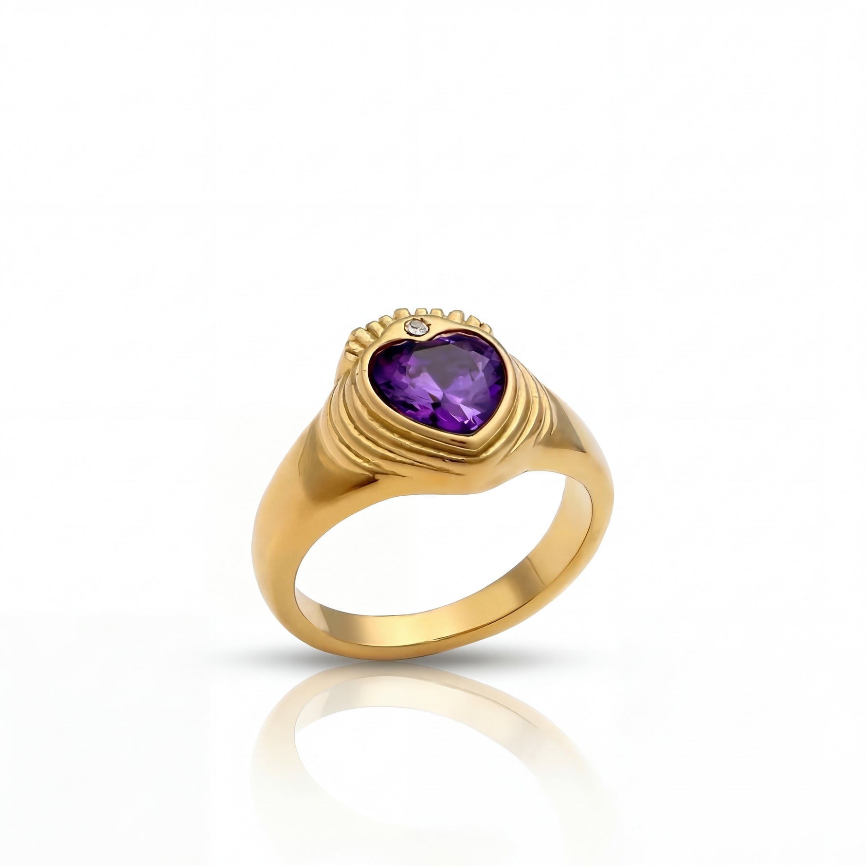 Gold ring with a heart-shaped purple gemstone on a white background