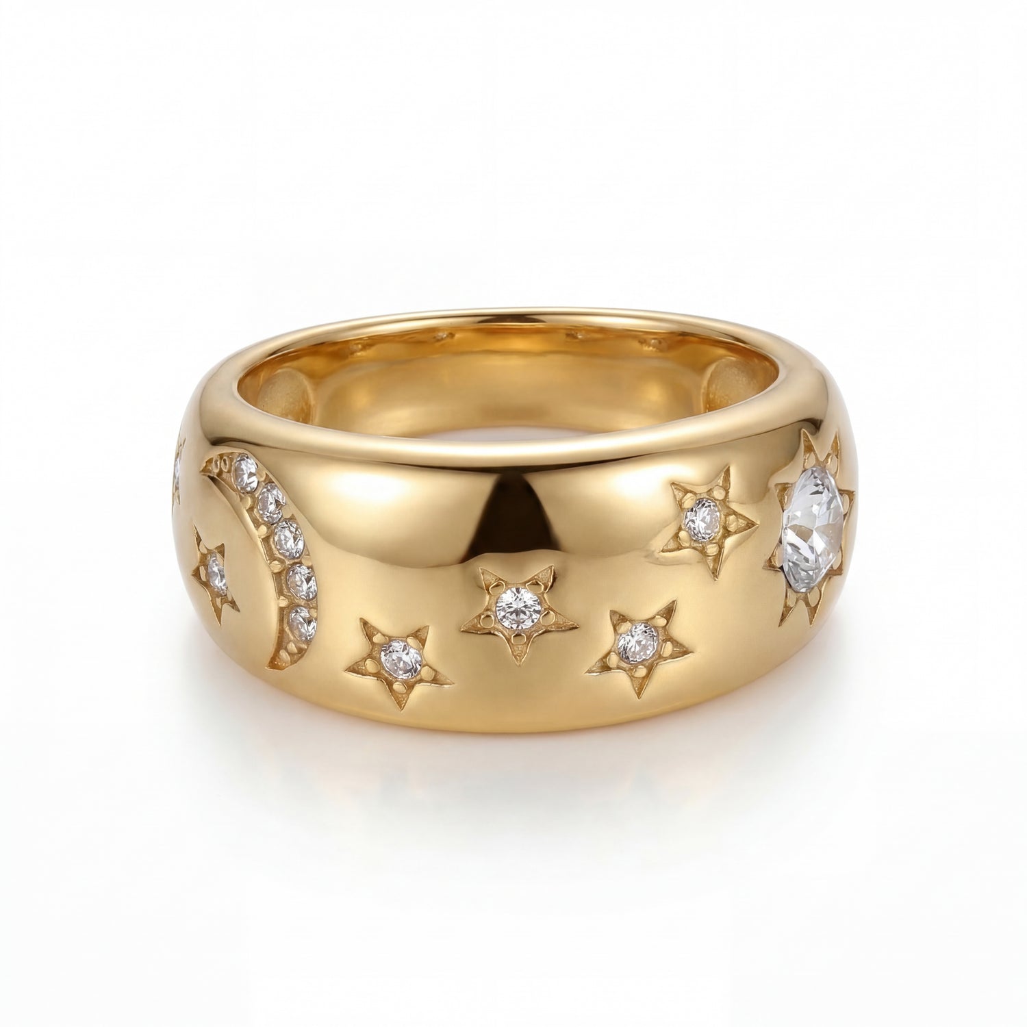 Gold ring with star and moon designs on a white background