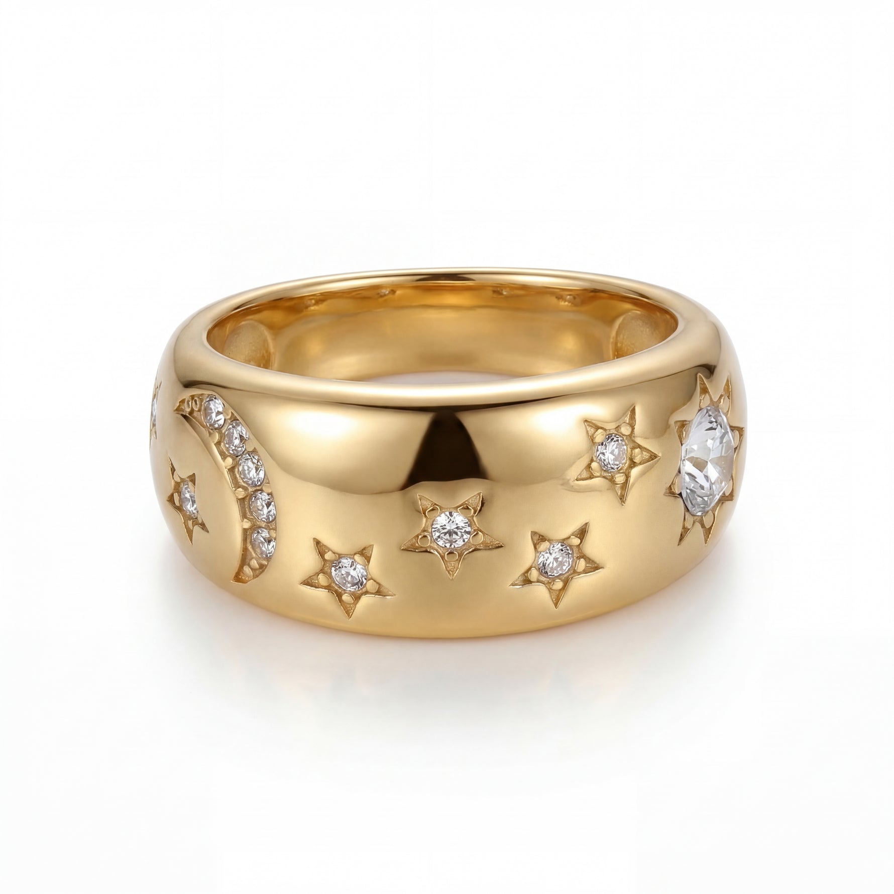 Gold ring with star and moon designs on a white background