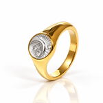 A polished yellow gold signet ring with a two-tone oval face, featuring a textured silver crescent moon and diamond details, set against a clean white background with a soft reflection.