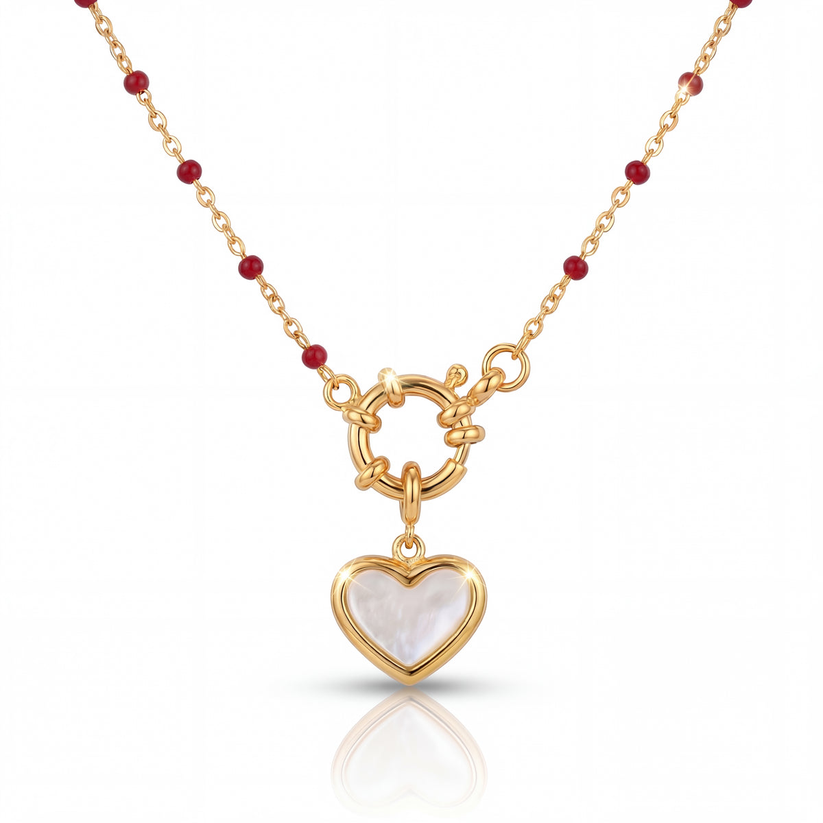 Gold necklace with a heart-shaped pendant on a white background