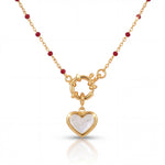 Gold necklace with a heart-shaped pendant on a white background