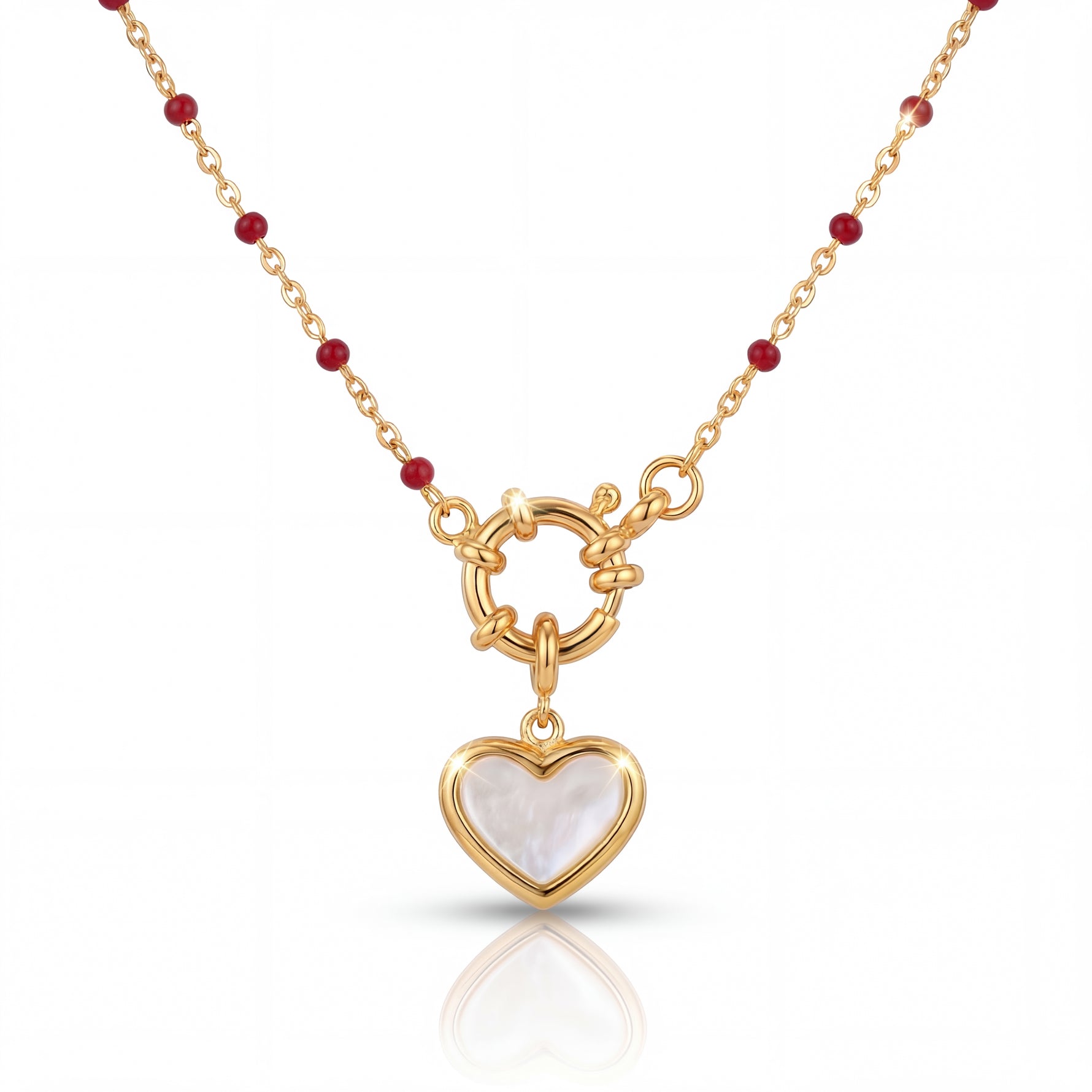 Gold necklace with a heart-shaped pendant on a white background