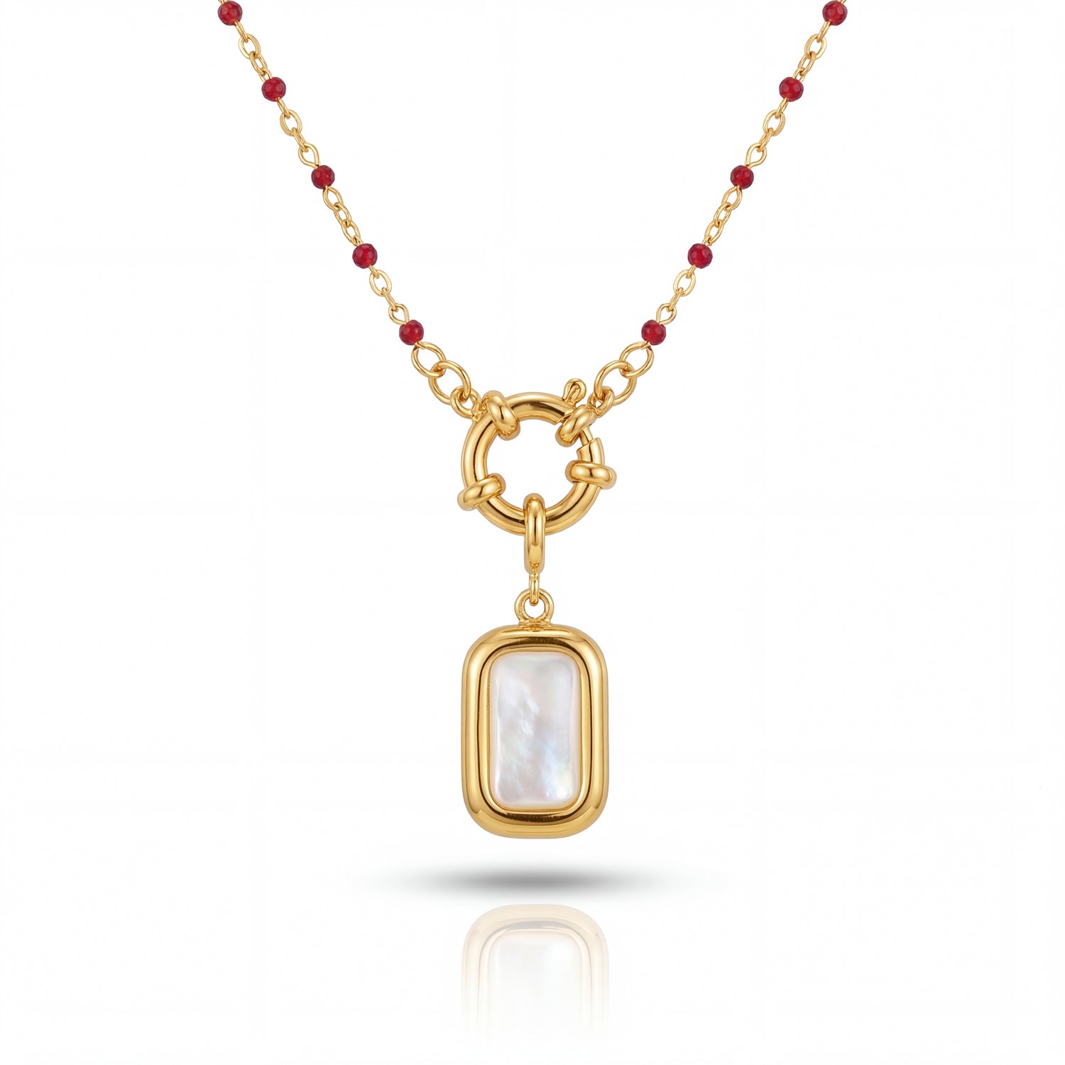 Gold necklace with a pendant featuring a white stone on a white background