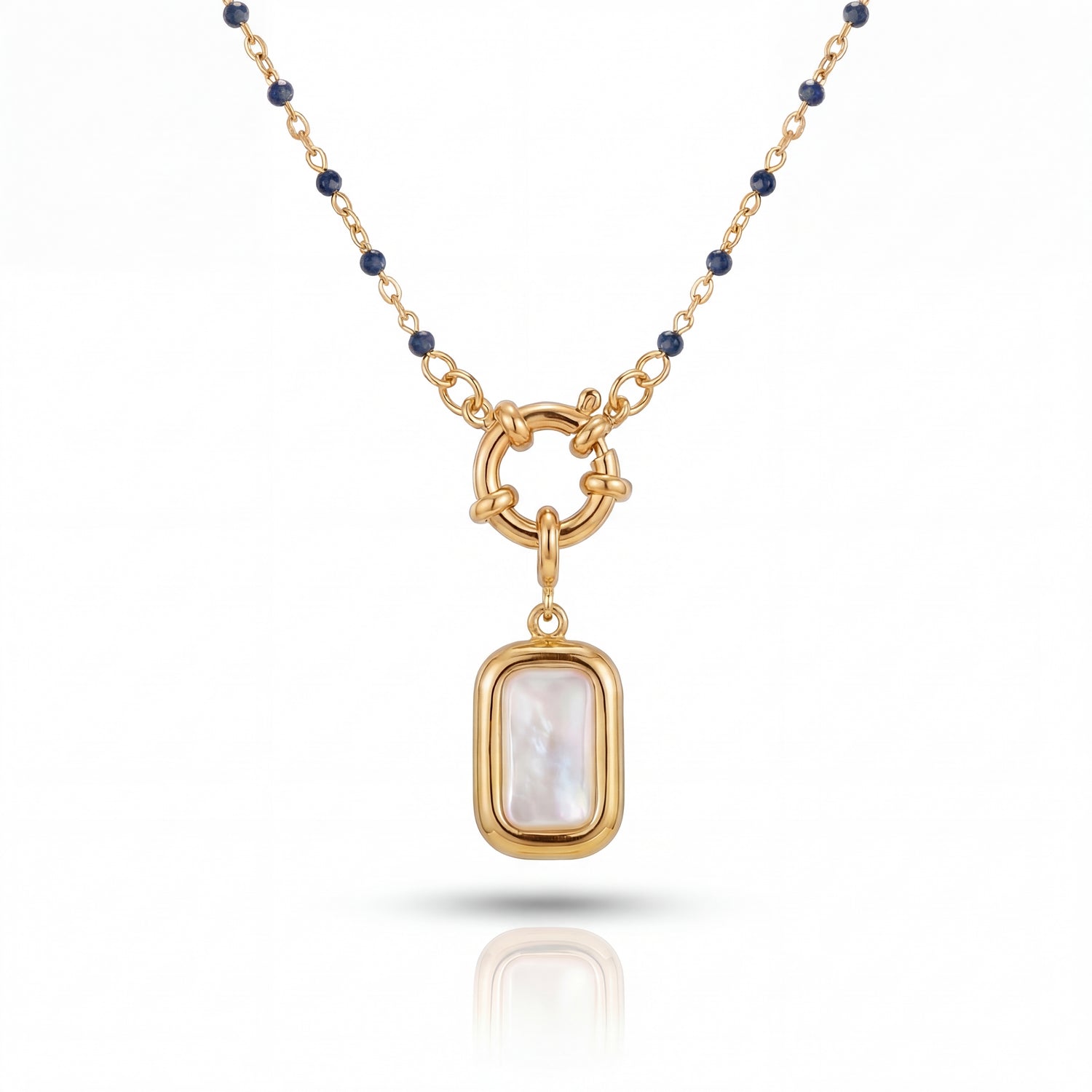 Gold necklace with a pendant featuring a white stone on a white background