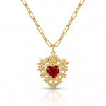 Gold necklace with a red heart pendant on a white background