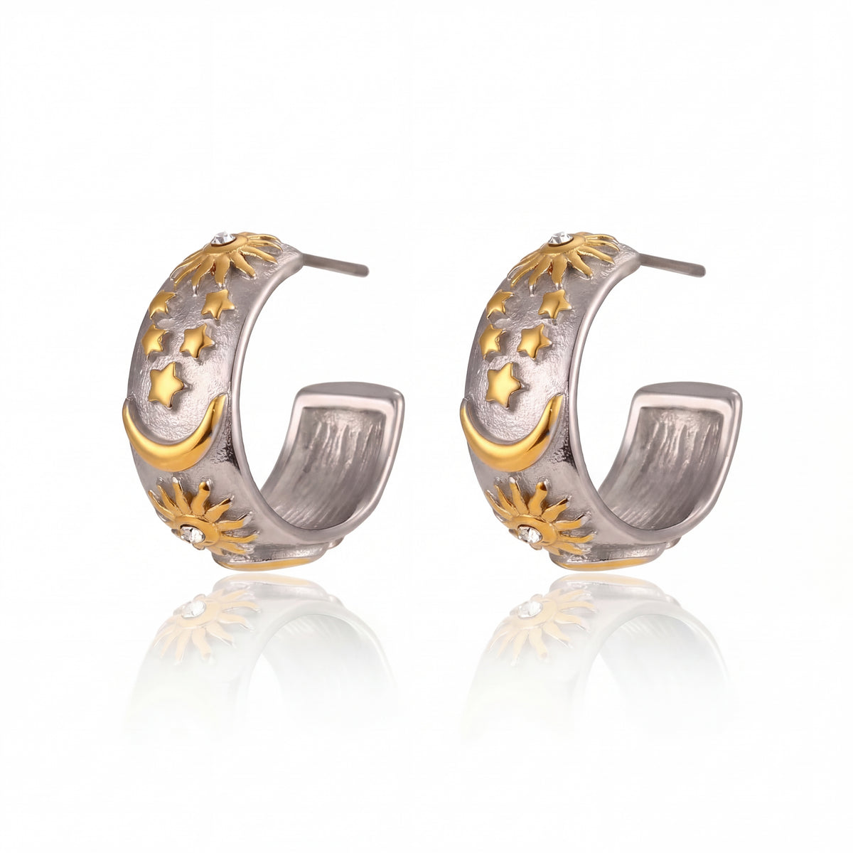 Pair of silver and gold hoop earrings on a white background
