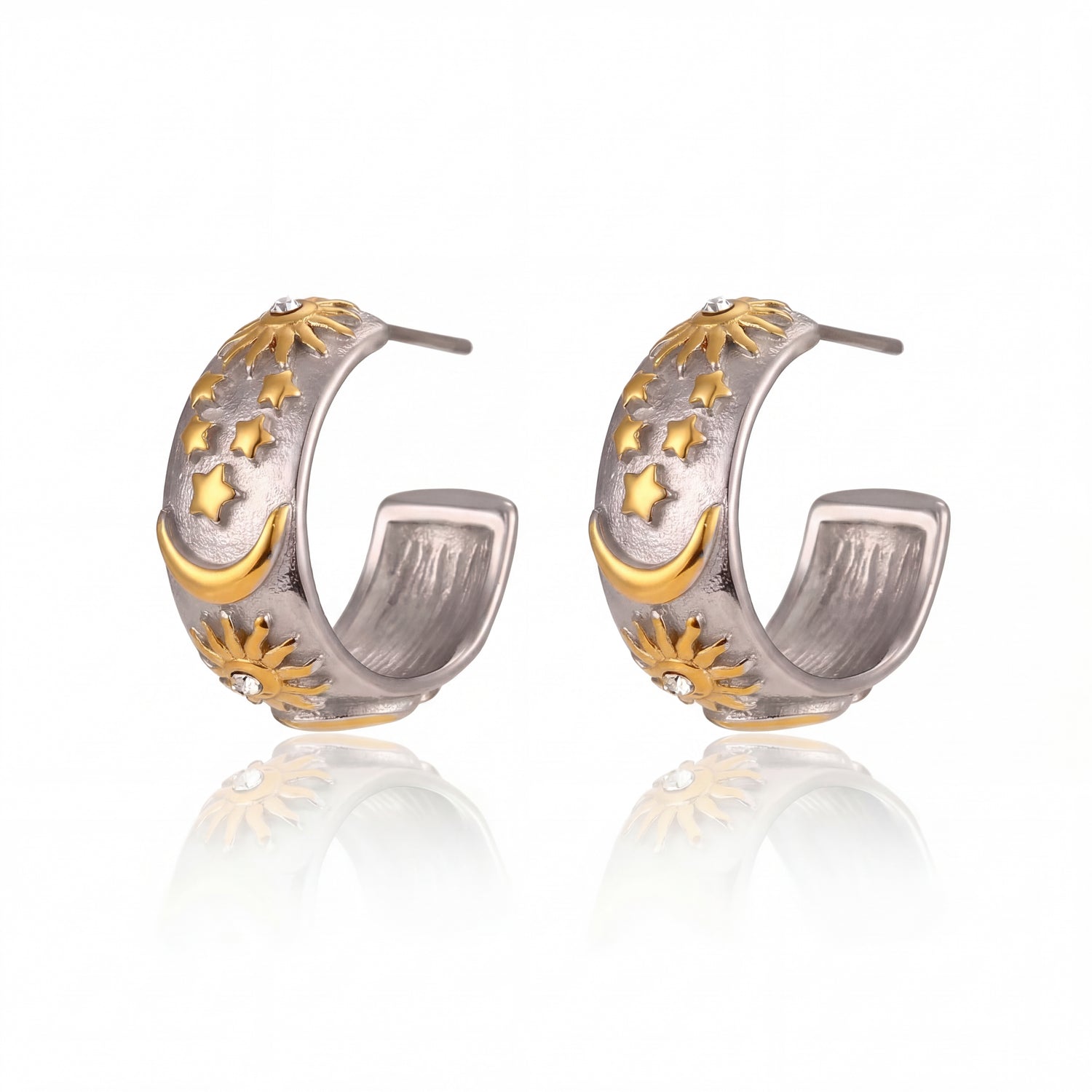 Pair of silver and gold hoop earrings on a white background