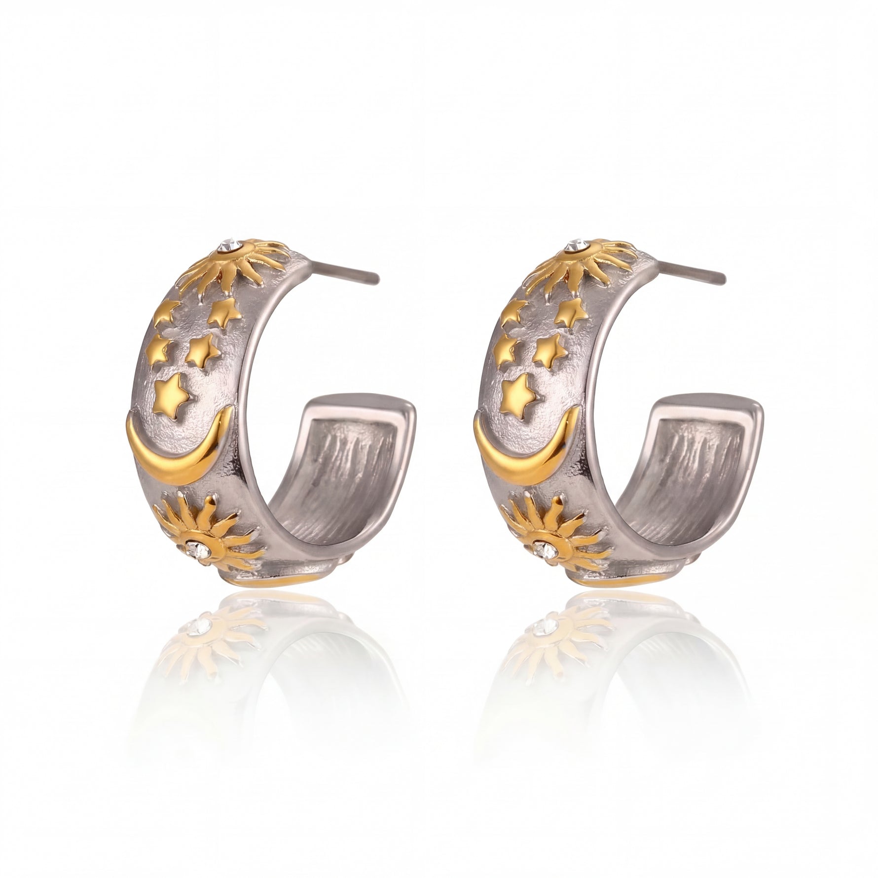 Pair of silver and gold hoop earrings on a white background