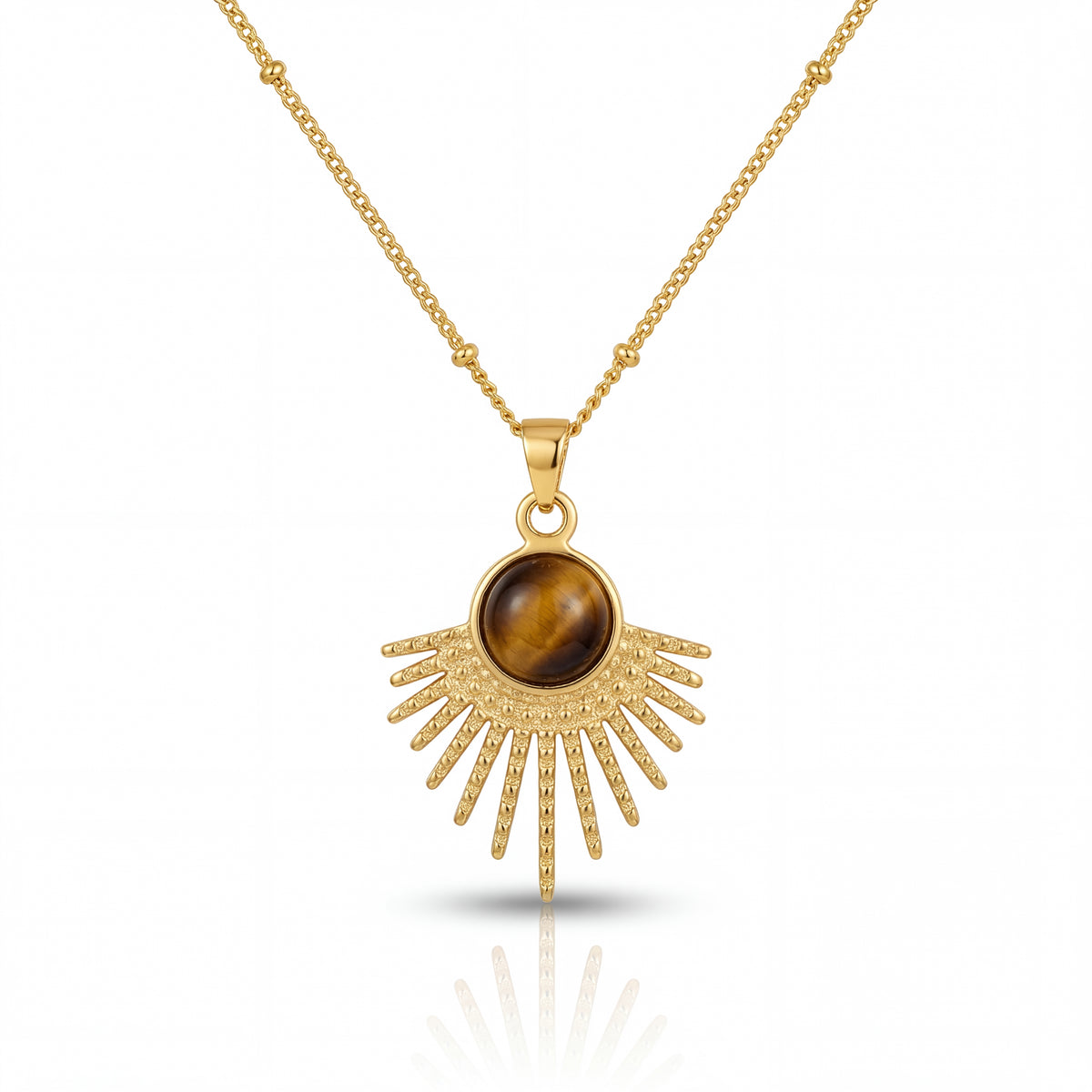 Gold necklace with a sunburst pendant featuring a brown gemstone on a white background
