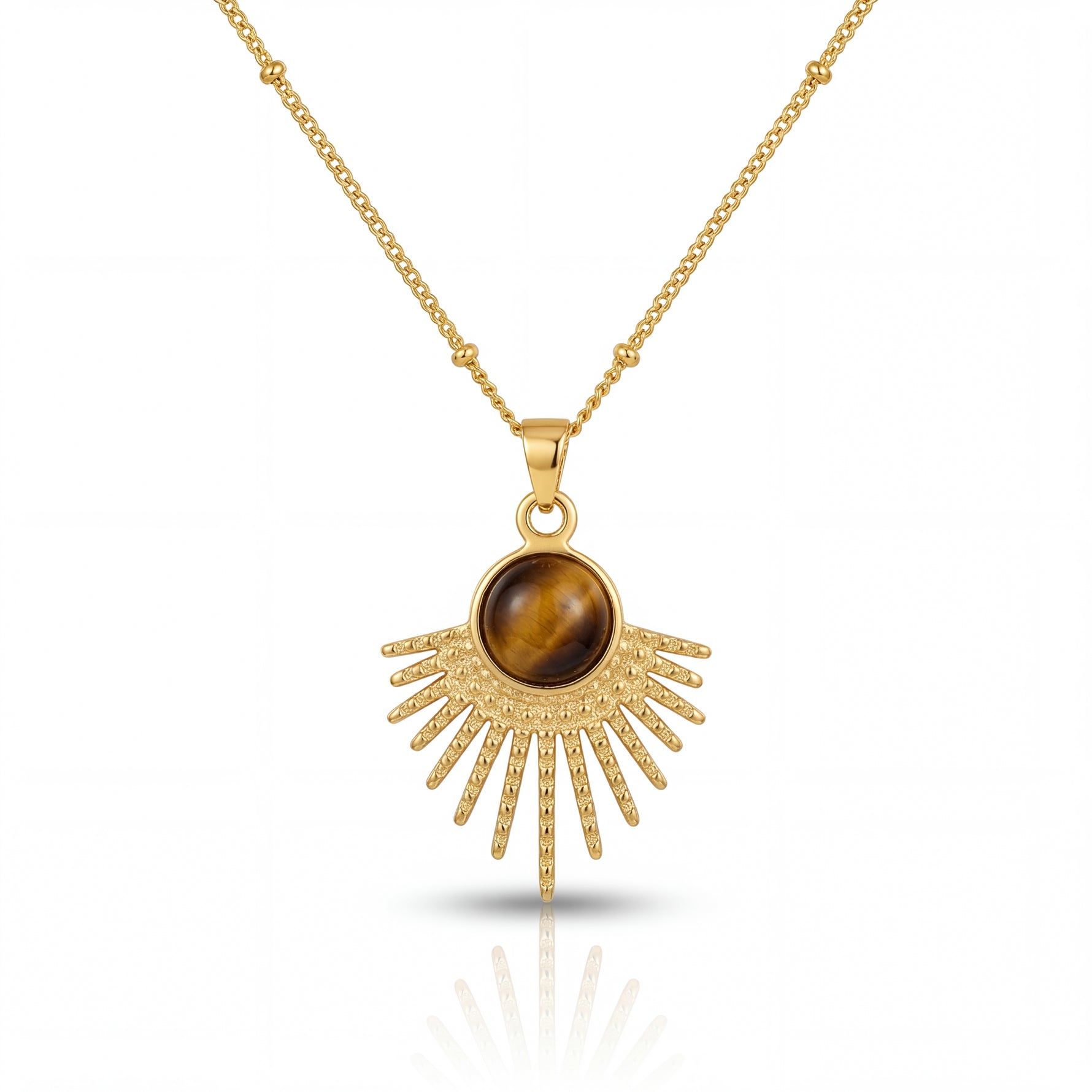 Gold necklace with a sunburst pendant featuring a brown gemstone on a white background