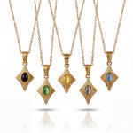 Set of gold necklaces with various gemstone pendants on a white background