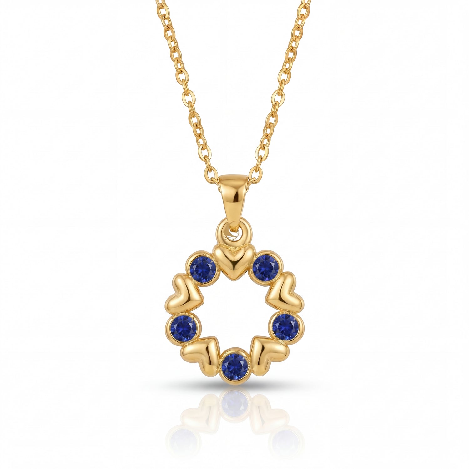 Gold necklace with a circular pendant featuring blue stones on a white background