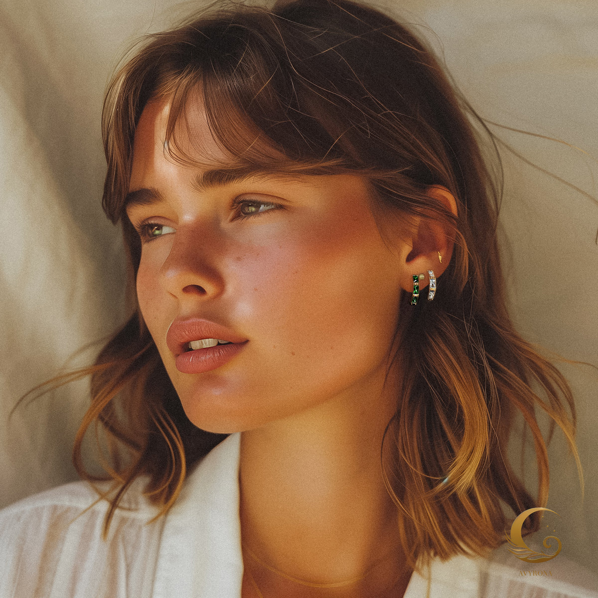 Female model wearing Camila earrings with clear zircon stones, styled with soft waves and natural makeup