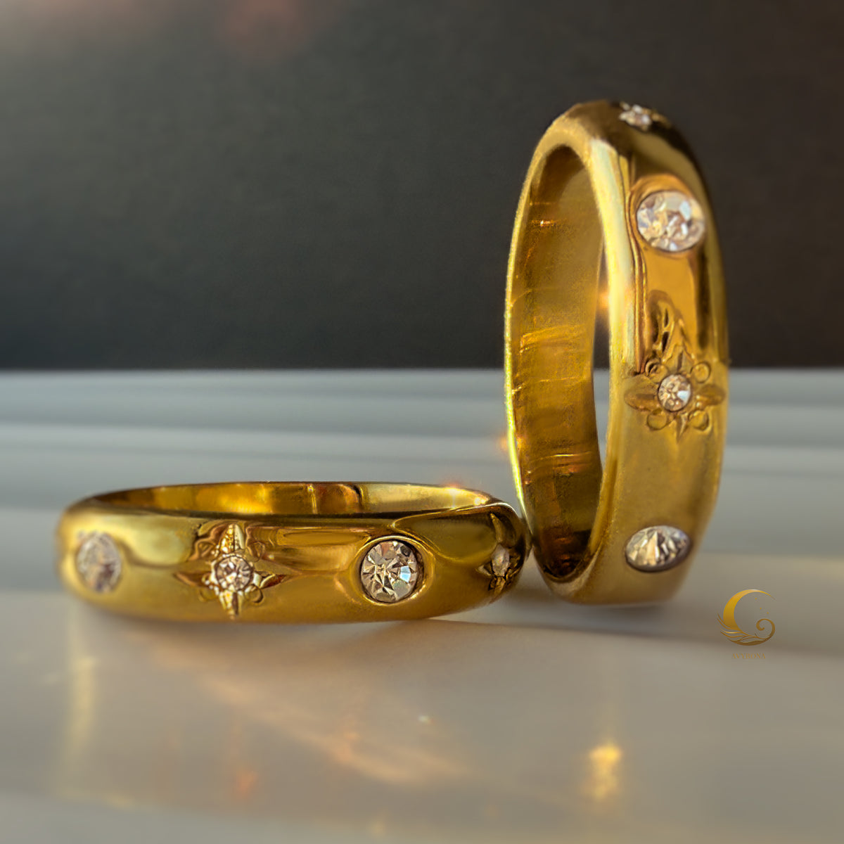 Macro view of engraved gold ring with star symbols and sparkling zircon stones