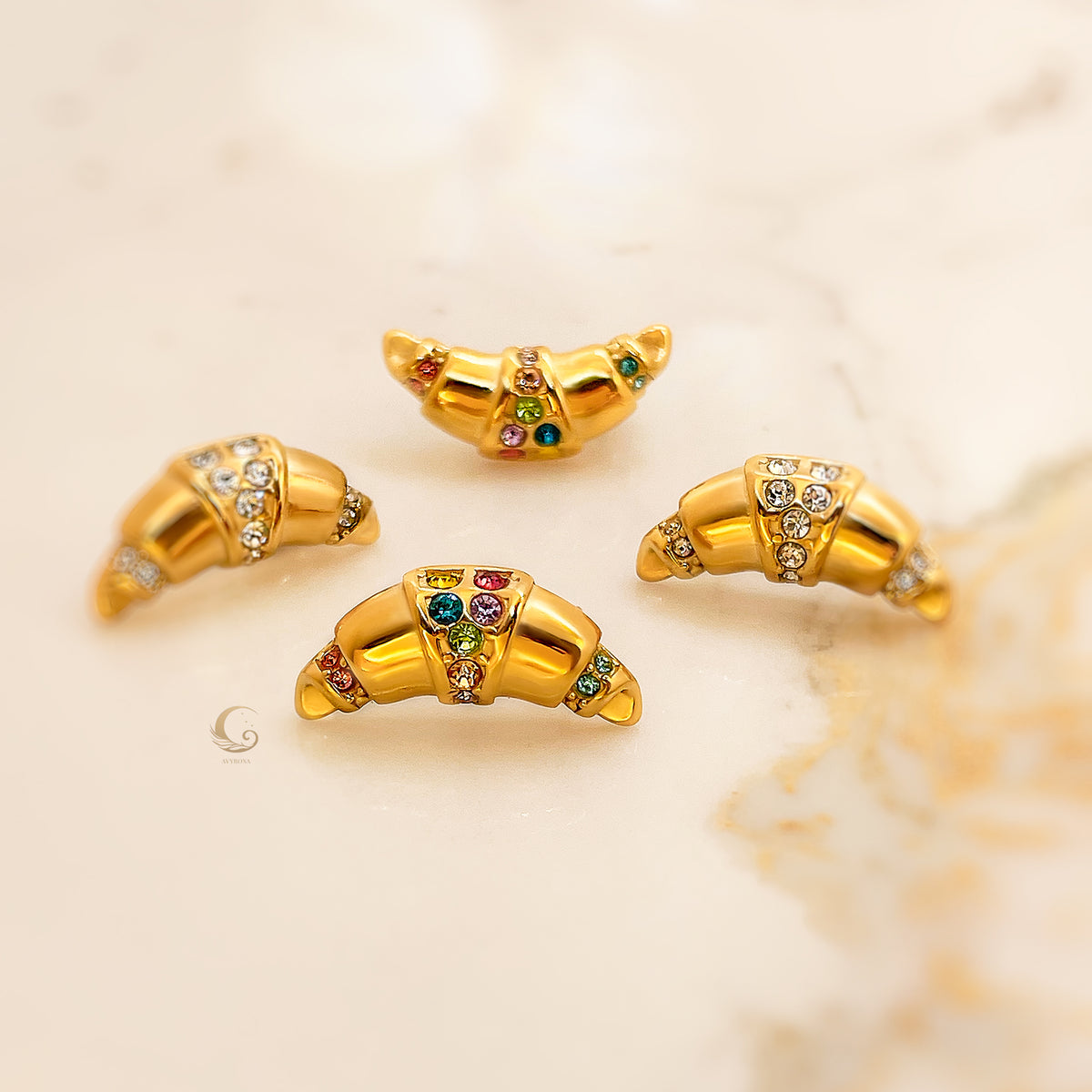 Gold croissant-shaped earrings with both clear and colorful zirconia, shown from different angles